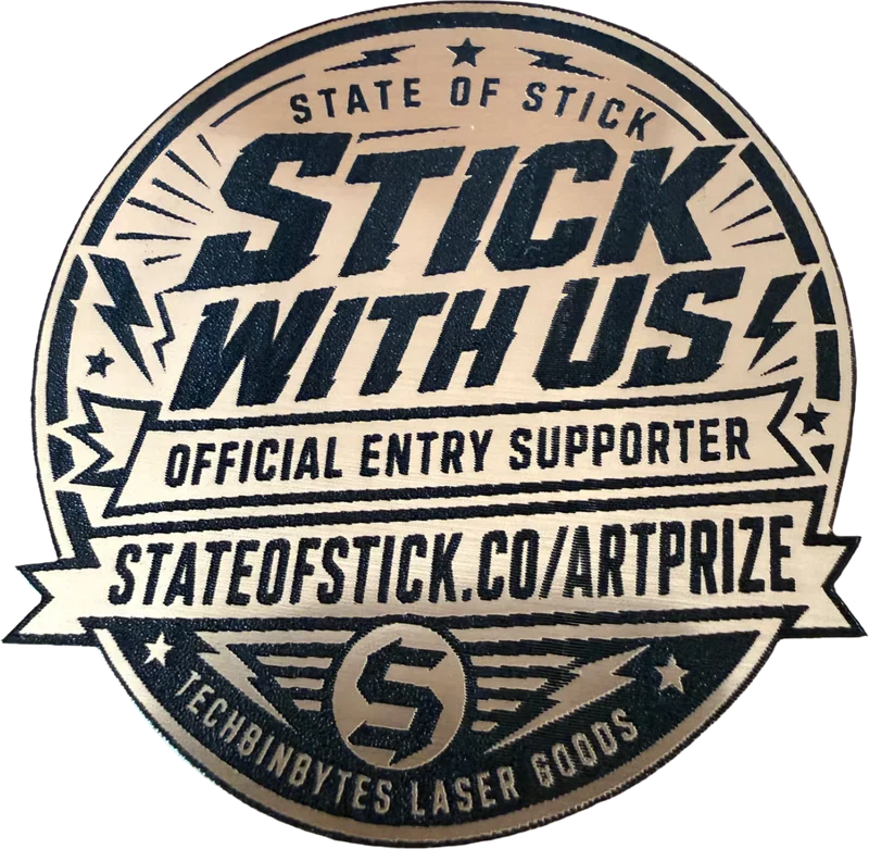 State of Stick ArtPrize official entry supporter badge — laser-finished metallic disc reading STICK WITH US
