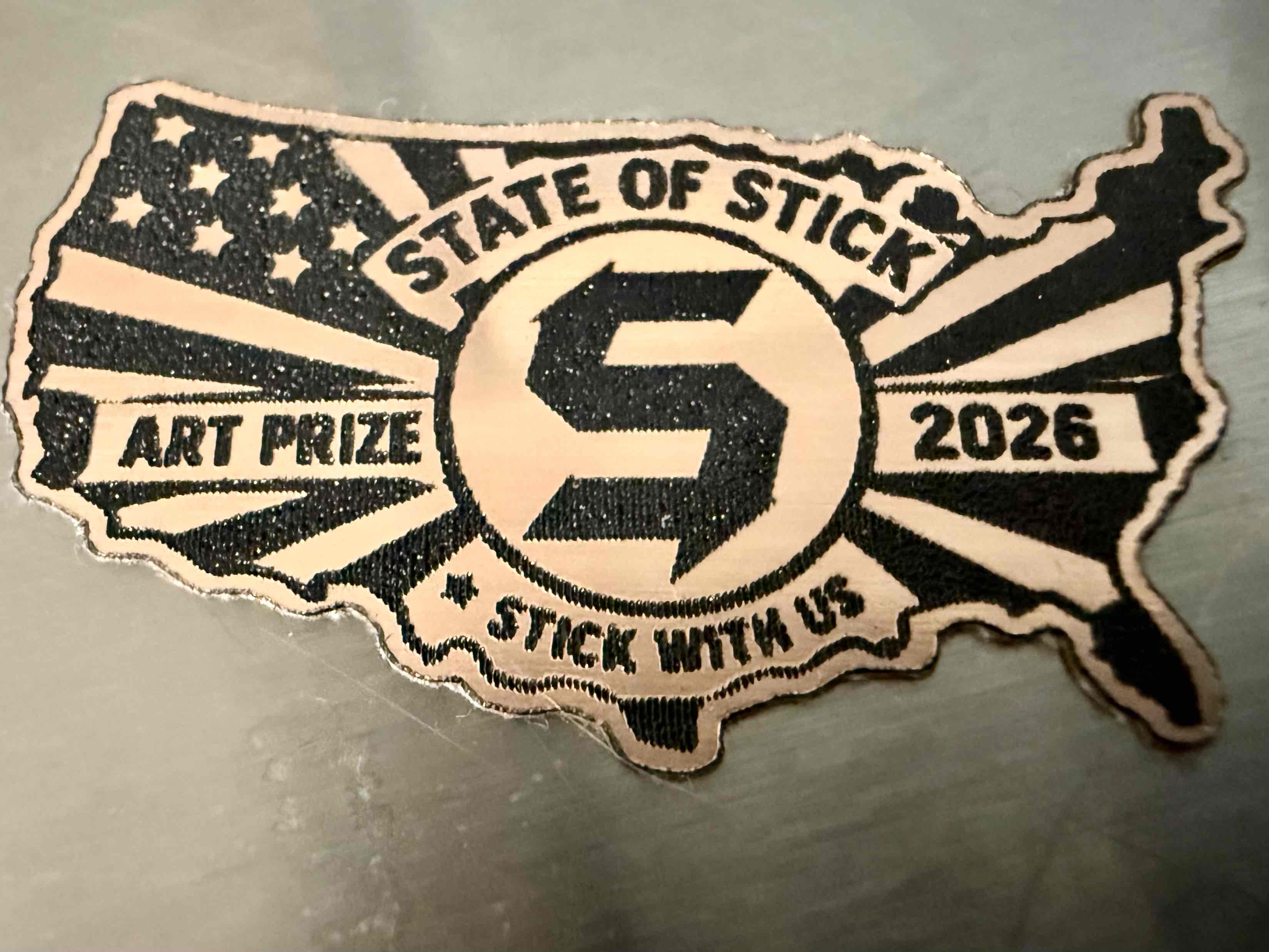 An eagle-shaped State of Stick ArtPrize 2026 emblem.